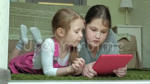 女孩们姐妹在房间里玩平板电脑上网休息视频的预览图