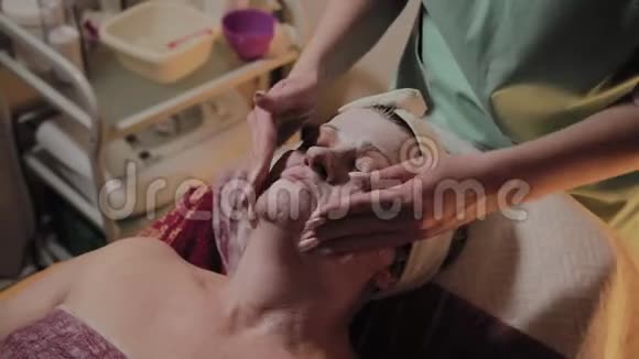 专业美容师为一位老年妇女做按摩Cosmetet创新视频的预览图