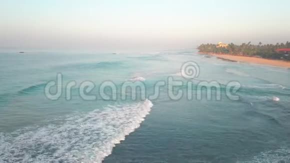 日落时的海浪斯里兰卡美丽的热带海滩与棕榈视频的预览图
