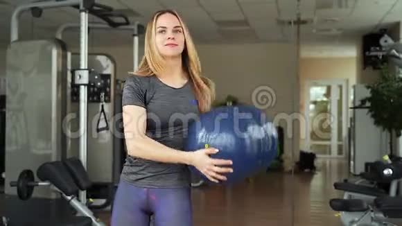 年轻迷人的女人在健身房做力量训练视频的预览图