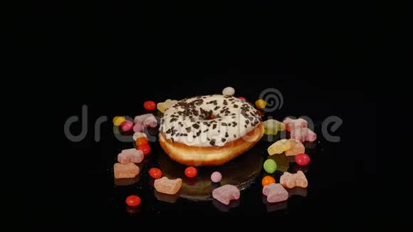 白色有趣的惊喜釉面甜甜圈与洒条纹焦糖糖果五颜六色的葡萄干或花生视频的预览图
