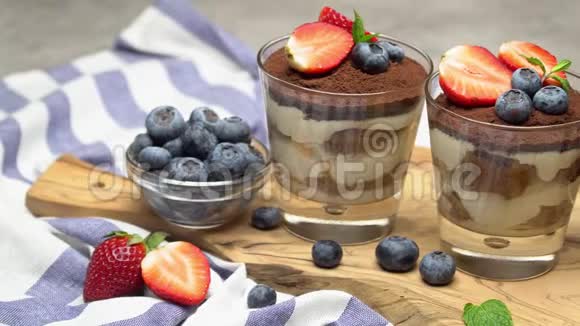 经典的提拉米苏甜点蓝莓和草莓在玻璃混凝土背景视频的预览图