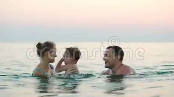 三个幸福的家庭在海里洗澡视频的预览图