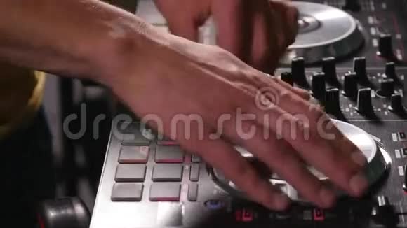 DJ在设备上混合歌曲双手特写视频的预览图