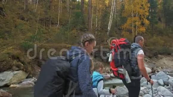人们走在河边家庭旅行人的环境由山河溪组成父母和子女视频的预览图