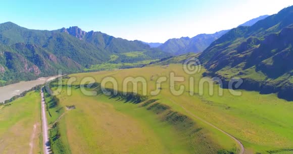 阳光明媚的夏季早晨空中乡村山路和草地沥青公路和河流视频的预览图