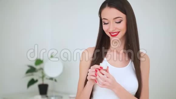 美容面部护理年轻女性完美护肤霜的肖像视频的预览图