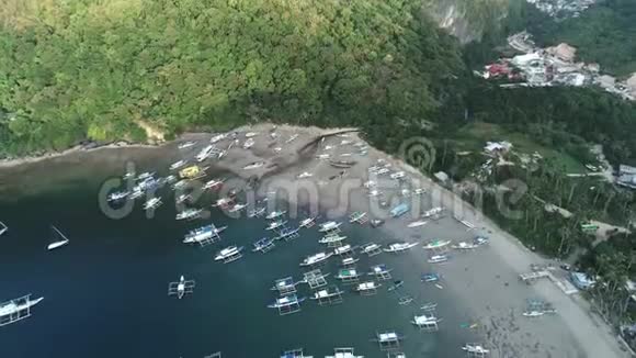 空中无人驾驶飞机观船停泊在海湾与清澈和绿松石水在热带泻湖的船和游艇视频的预览图