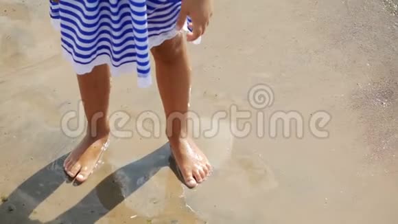 小女孩蓝色条纹连衣裙在海边视频的预览图