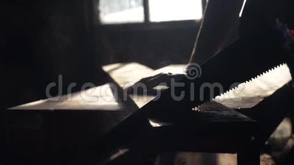 匠心手工与工艺概念慢动作视频木匠在生活中锯树在车间里锯阳光视频的预览图
