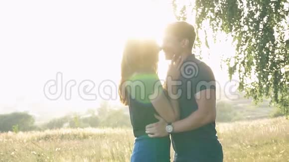 在树叶的背景下一对年轻的恋人在大自然中视频的预览图