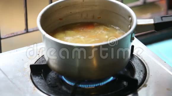 在煤气炉上用平底锅搅拌鸡汤视频的预览图