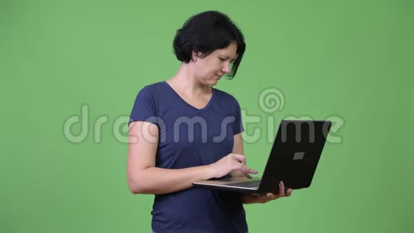 一位留着短头发的漂亮女士用笔记本电脑视频的预览图