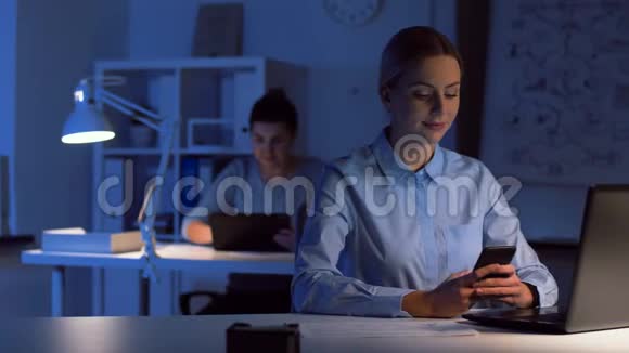 黑夜办公室带智能手机的女商人视频的预览图