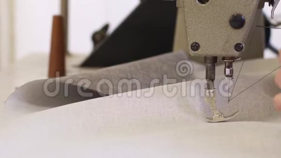 家具厂里一位正在为沙发缝制材料的老妇人的特写镜头视频的预览图