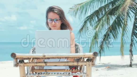 在海滩上工作的女自由职业者视频的预览图