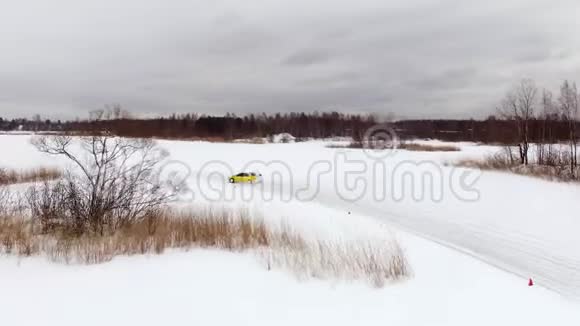 冬天在雪覆盖的湖面上汽车在结冰的轨道上行驶空中观景冬季雪地赛道上的赛车视频的预览图