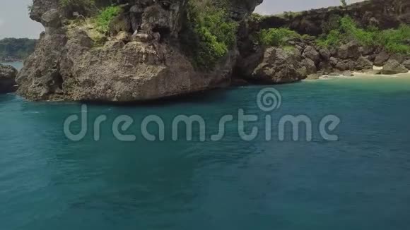 鸟瞰蓝色海水和岩石悬崖景观从无人驾驶的绿松石海水和岩石岛的美丽景色视频的预览图