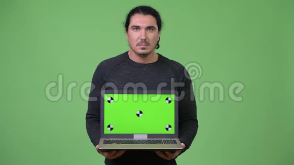 快乐英俊的男人展示笔记本电脑视频的预览图