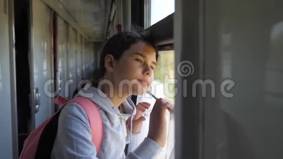 小女孩十几岁是乘火车旅行的背包客旅游运输铁路概念旅游学校的女孩视频的预览图
