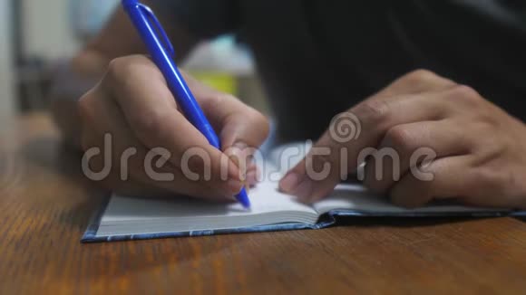 人在笔记本上写字男性手写记事本概念商业教育男人在笔记本上做笔记视频的预览图