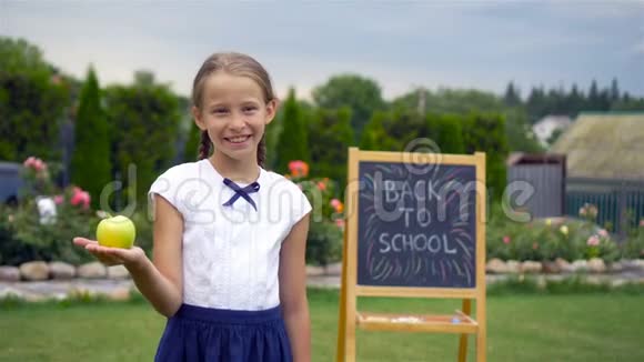 快乐的小女生带着黑板户外视频的预览图