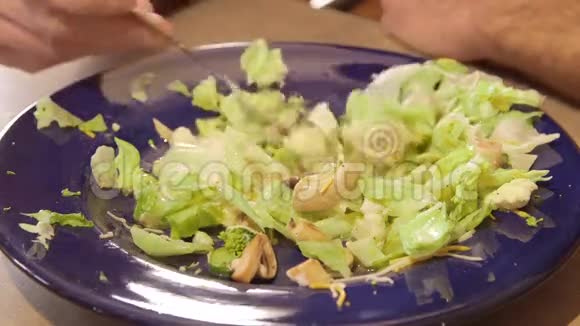 男人吃新鲜蔬菜和生菜做的沙拉视频的预览图
