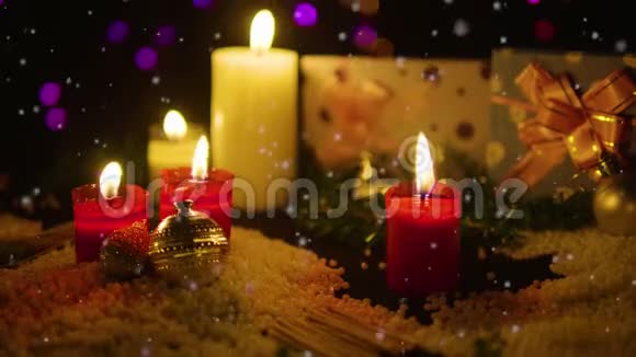 装饰圣诞节与蜡烛燃烧礼物和雪镜头圣诞节视频的预览图