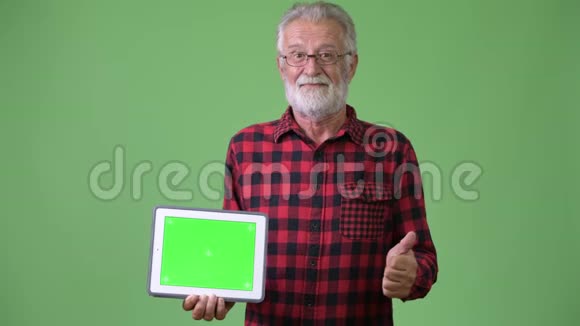 绿色背景下英俊的大胡子男人视频的预览图