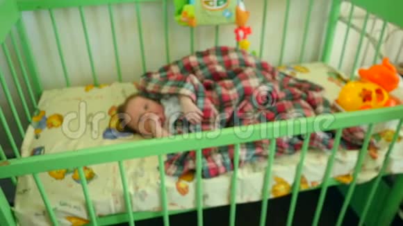 可爱的婴儿躺在婴儿床上视频的预览图