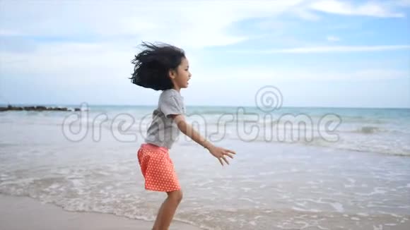 亚洲小女孩在海滩上玩耍视频的预览图