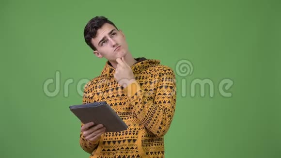 年轻的帅哥在用数码平板电脑思考视频的预览图