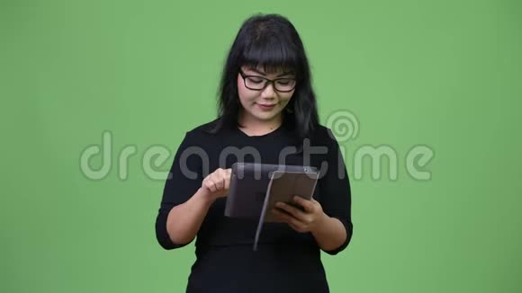 美丽的亚洲女商人使用数字平板电脑视频的预览图