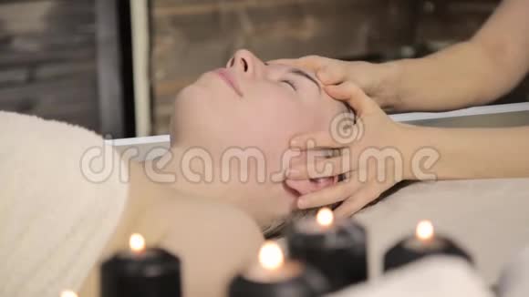 美容师在水疗沙龙为美女做面部按摩视频的预览图