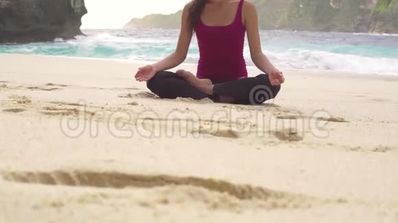做瑜伽的女人莲花在海滩上的姿势视频的预览图
