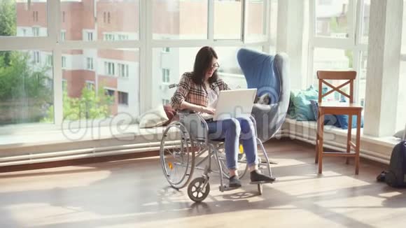 坐轮椅的残疾妇女带手提电脑视频的预览图