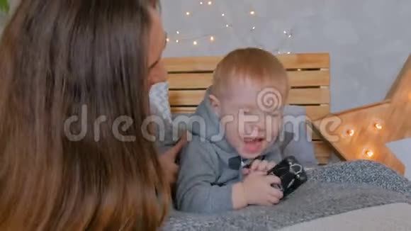 快乐的年轻母亲和她的小儿子在玩托格舍视频的预览图
