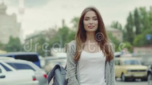 美丽的年轻女子走在街上视频的预览图