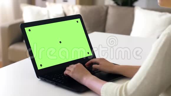 手提电脑上有彩色钥匙绿色屏幕的女人视频的预览图