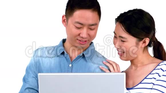 亚洲微笑夫妇使用笔记本电脑视频的预览图
