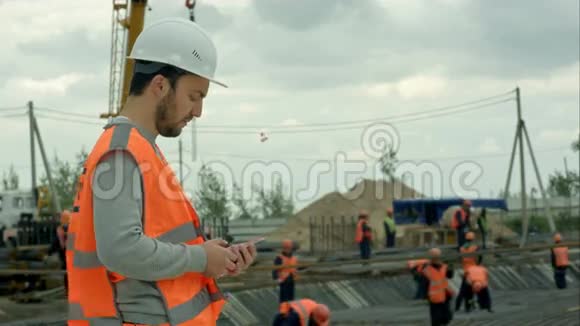 建筑工人在建筑工地打电话视频的预览图