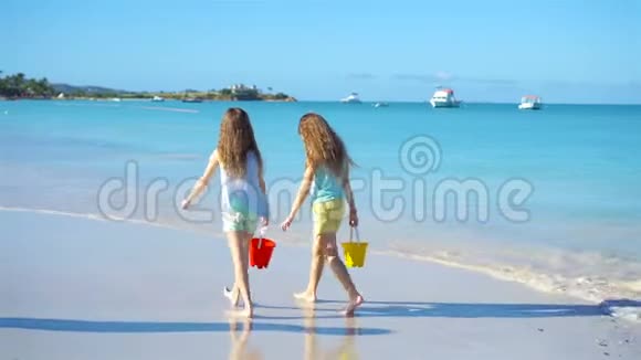 可爱的小女孩在海滩上散步一起玩视频的预览图