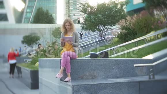 年轻的时髦女人正在城市公园商业中心散步视频的预览图