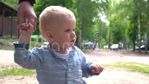 快乐可爱的宝宝和爸爸在公园散步视频的预览图