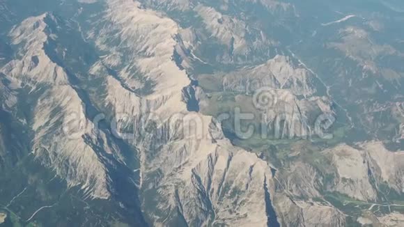 在夏季飞越阿尔卑斯山从飞机窗口可以看到空中景色视频的预览图