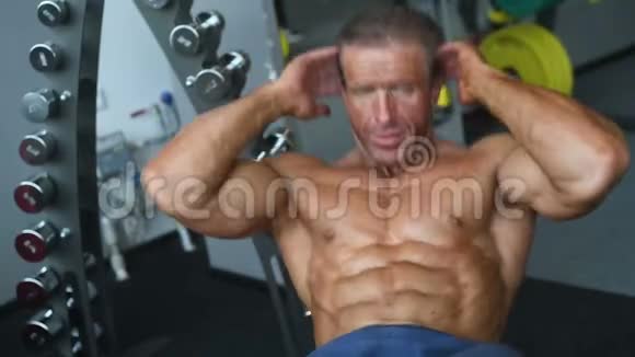 强壮强壮的健美运动员用哑铃给肌肉打气视频的预览图