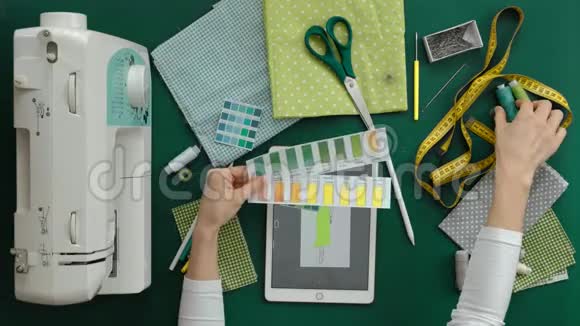 女裁缝设计师服装表顶部视图绿色背景视频的预览图