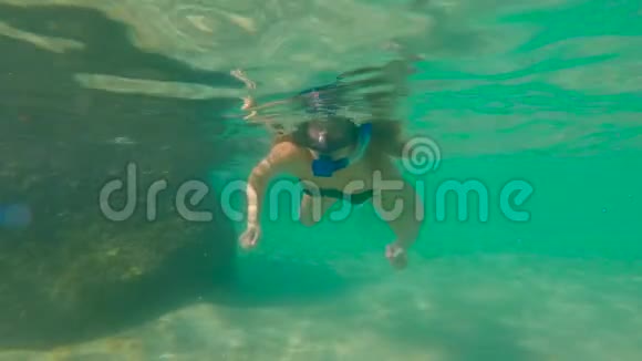 一个年轻女子在海里浮潜的慢镜头视频的预览图
