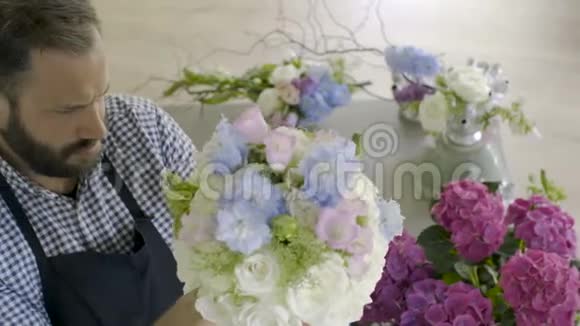 年轻的花匠家庭在花店准备花束视频的预览图