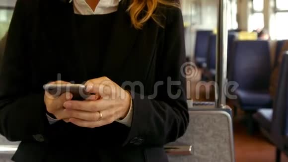 女商人在火车上用电话视频的预览图